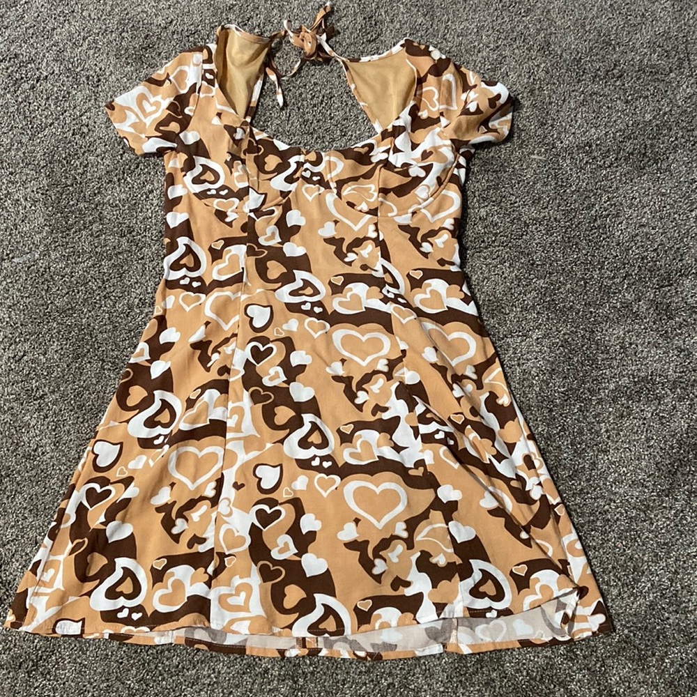 The size is small and is a dress. Their are cute heart designs on the dress.